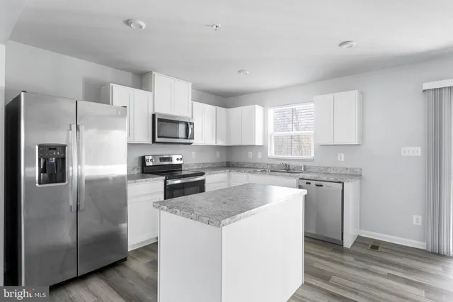 a kitchen with a refrigerator sink and microwave