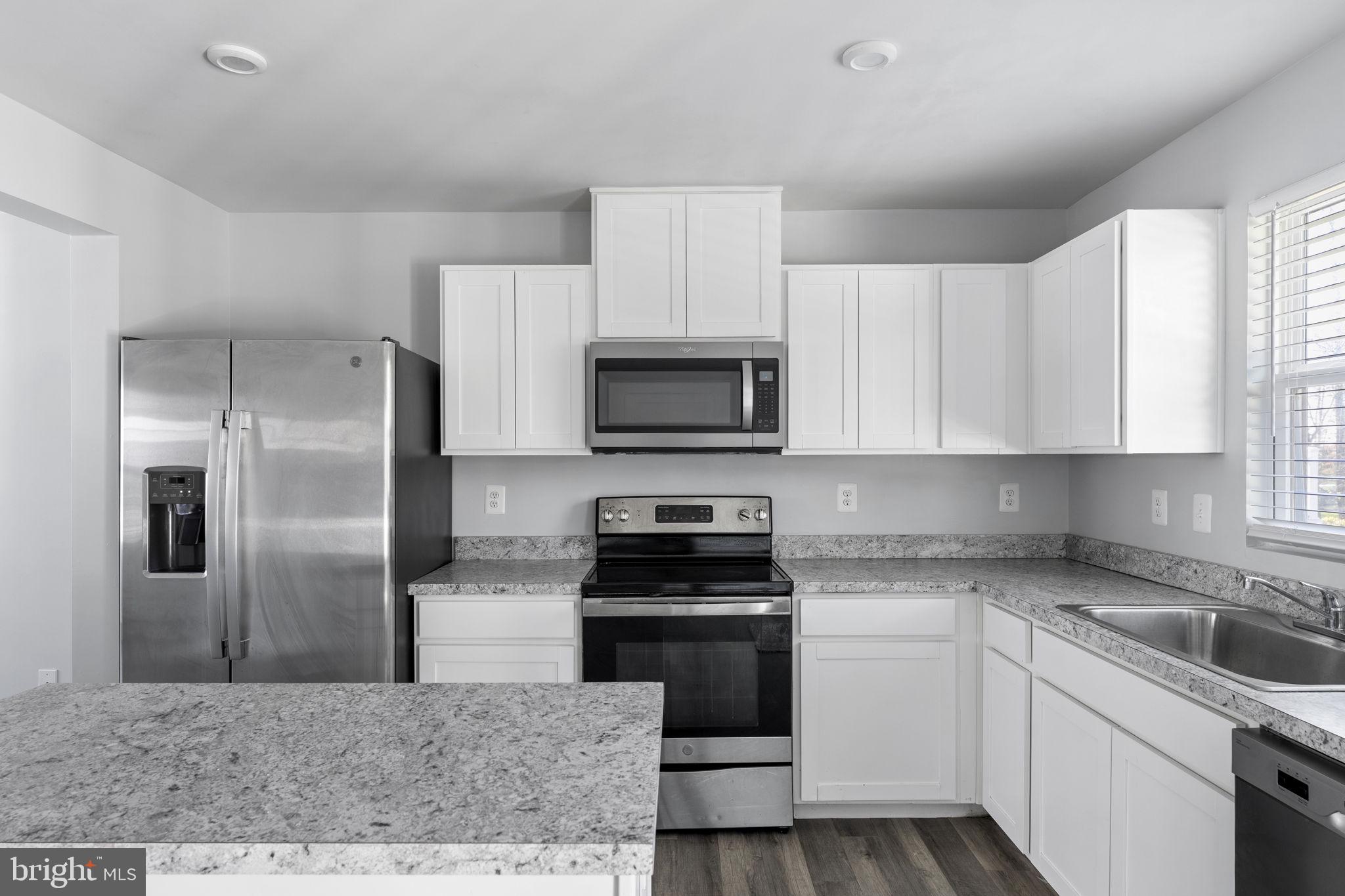 152 Ben Boulevard Elkton, MD 21921 - Photo 7 of 34 a kitchen with a sink stove and refrigerator