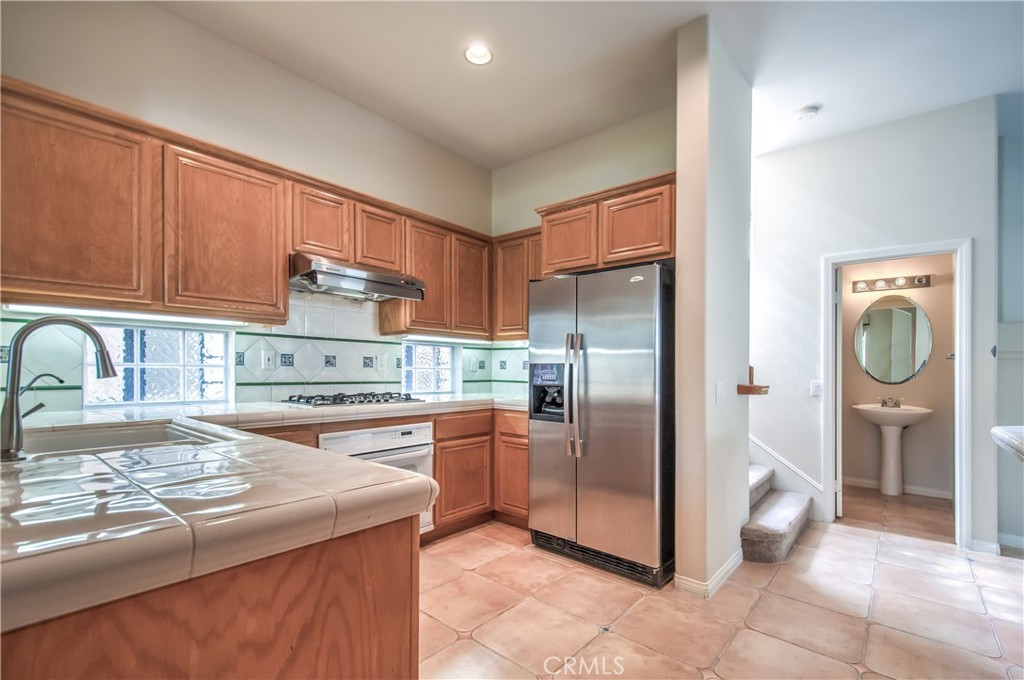 2 Altezza Irvine, CA 92606 - Photo 22 of 66 a kitchen with stainless steel appliances granite countertop a refrigerator a stove and a sink with cabinets