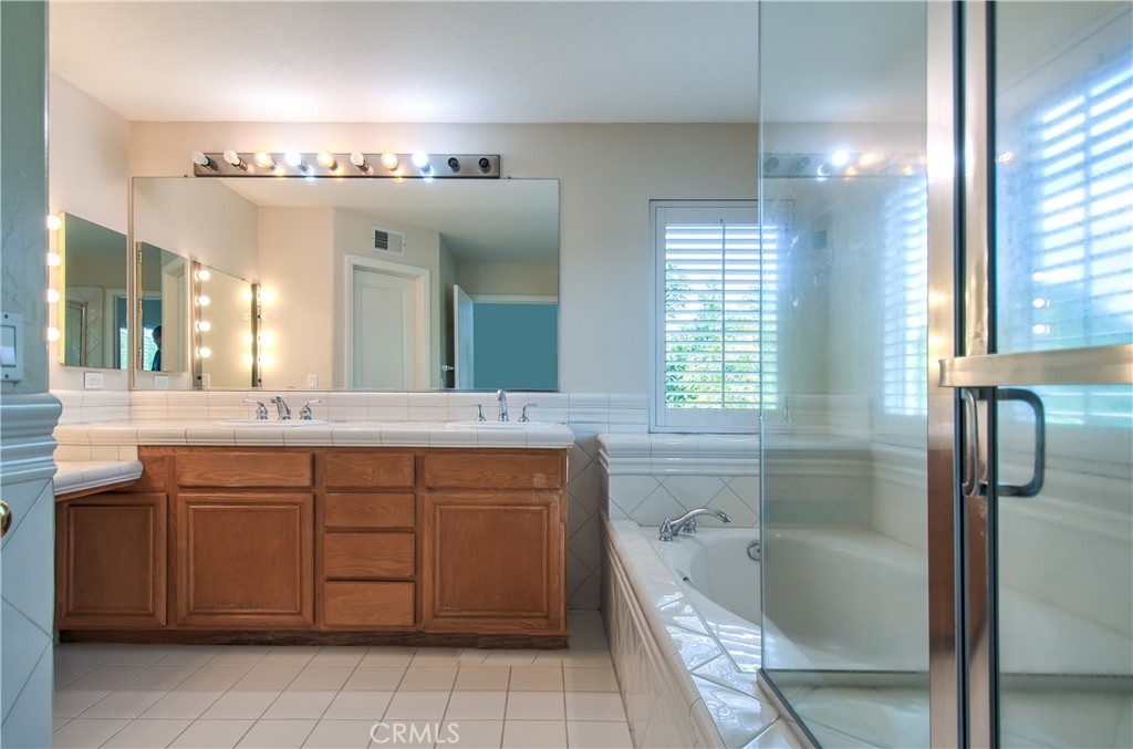 2 Altezza Irvine, CA 92606 - Photo 41 of 66 a bathroom with a granite countertop sink a toilet a mirror and bathtub