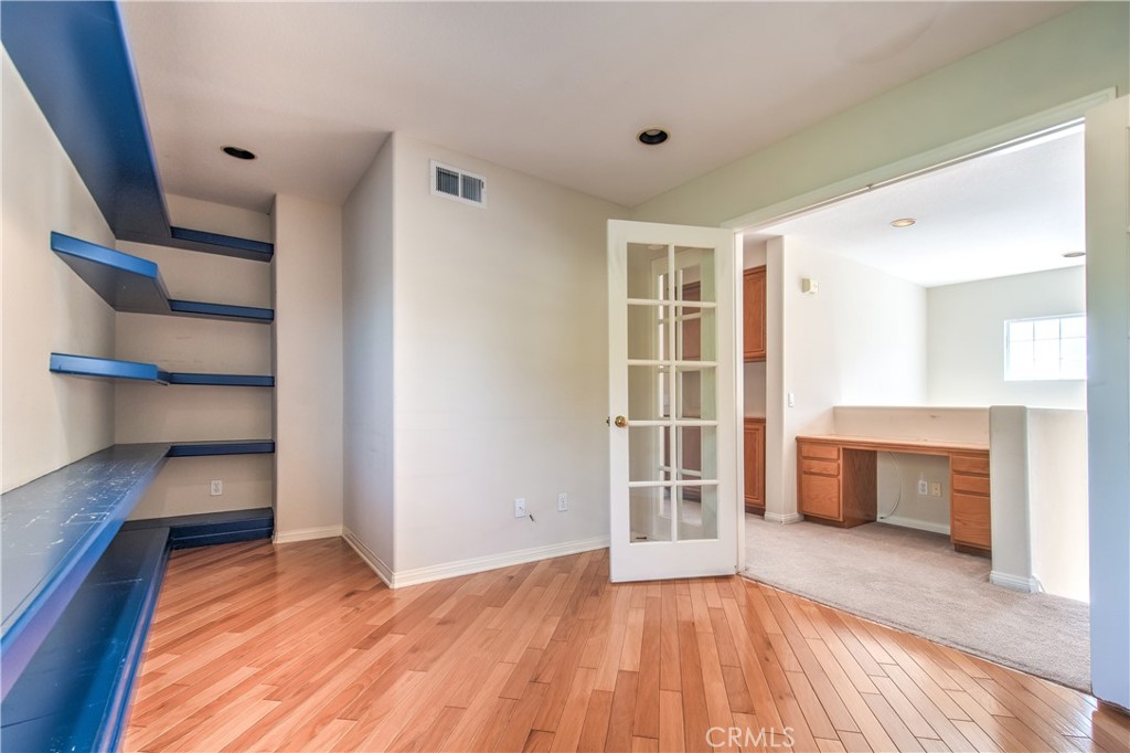 2 Altezza Irvine, CA 92606 - Photo 48 of 66 a view of empty room with wooden floor and fireplace