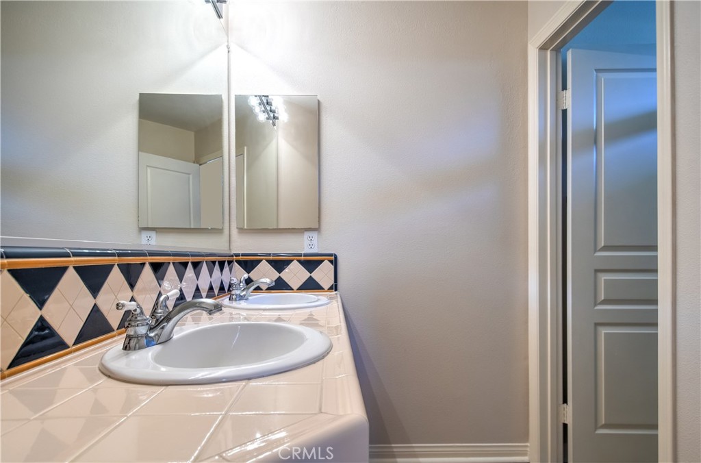 2 Altezza Irvine, CA 92606 - Photo 55 of 66 a bathroom with a sink a mirror and a bathtub