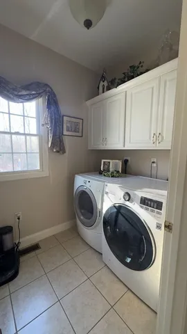 a utility room with sink dryer and washer