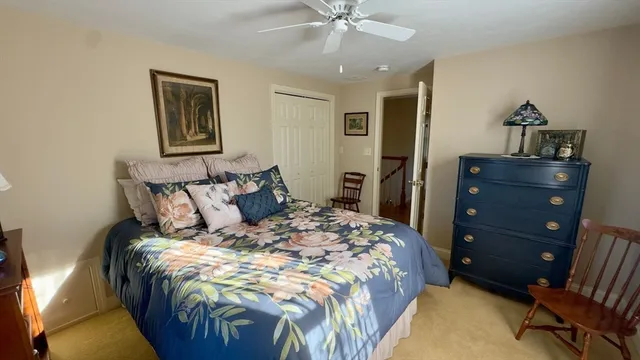 a bed sitting in a bedroom and chair