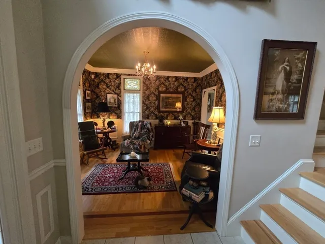 a view of living room with furniture and a floor to ceiling window