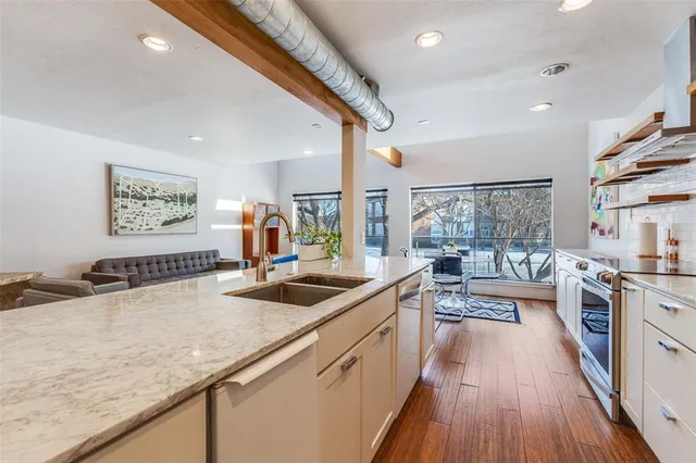 a kitchen with sink stove and refrigerator
