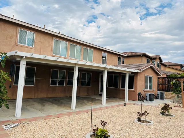 a backyard of a house with yard and outdoor seating