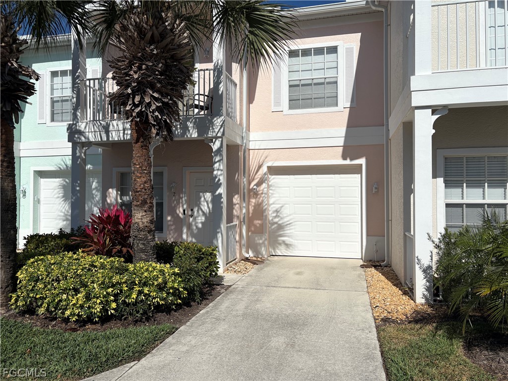 3269 Amanda Lane, Unit 2 Naples, FL 34109 - Photo 1 of 38 a front view of a house having yard