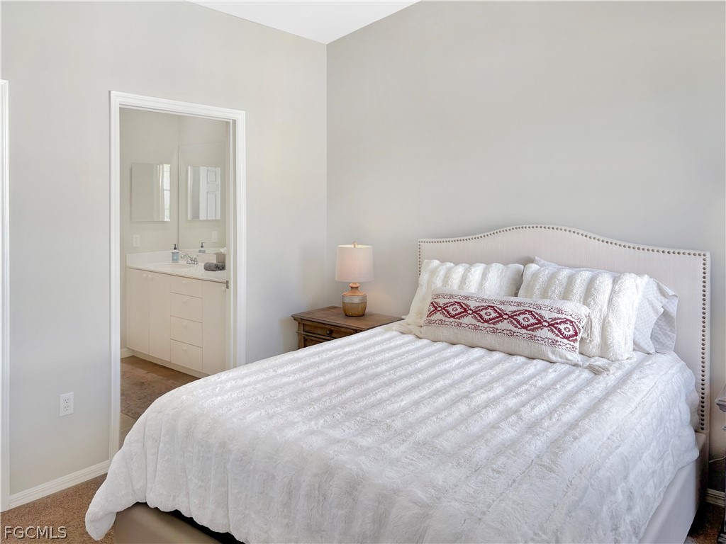 3269 Amanda Lane, Unit 2 Naples, FL 34109 - Photo 14 of 38 a bedroom with a bed and mirror