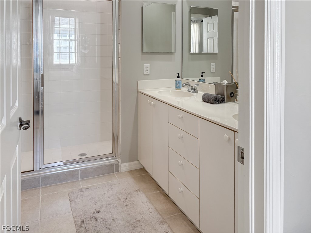 3269 Amanda Lane, Unit 2 Naples, FL 34109 - Photo 16 of 38 a bathroom with a sink and a mirror