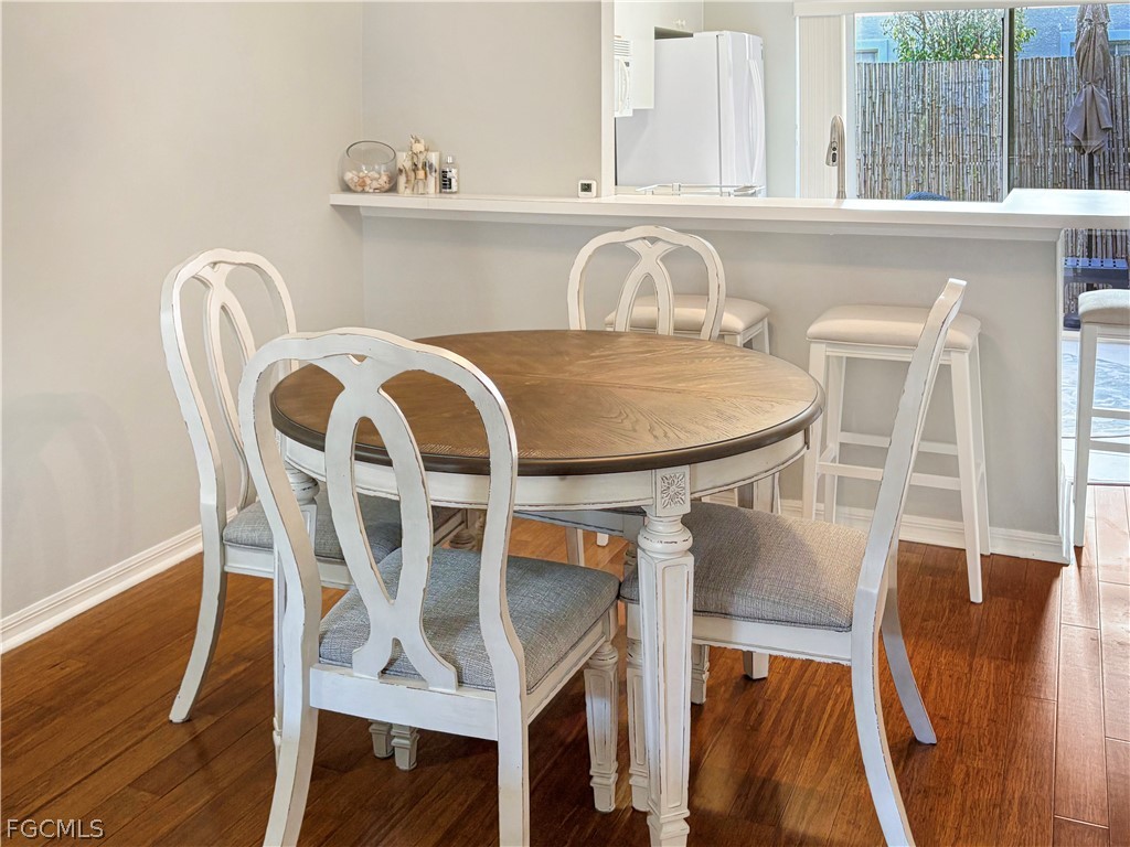 3269 Amanda Lane, Unit 2 Naples, FL 34109 - Photo 6 of 38 a view of a dining room with furniture and wooden floor