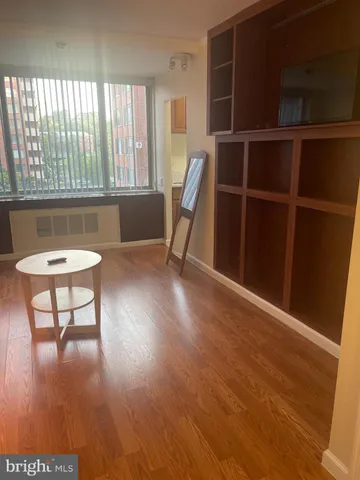 a view of a workspace with furniture and a window