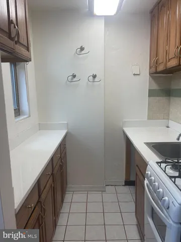a kitchen with a sink a stove and cabinets