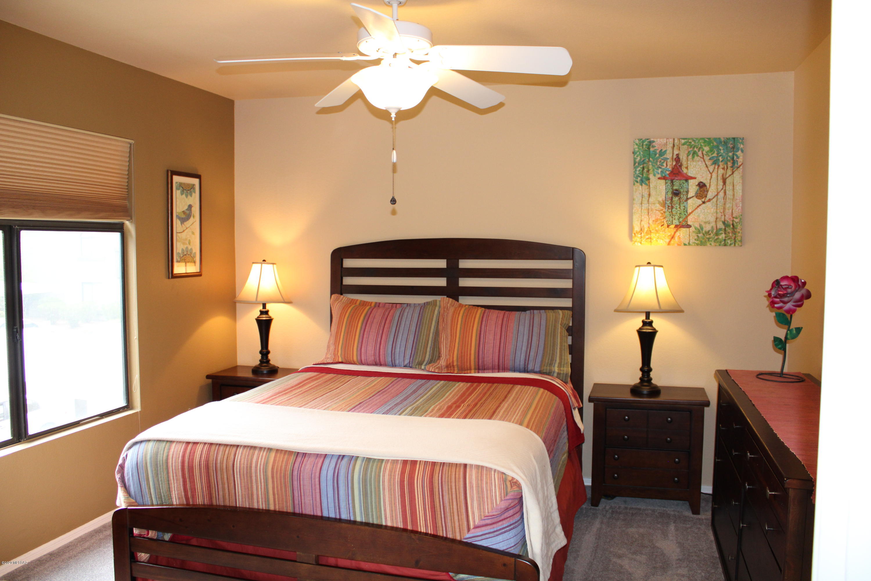 5751 North Kolb Road, Unit 36203 Tucson, AZ 85750 - Photo 20 of 25 a bedroom with a bed and a chandelier