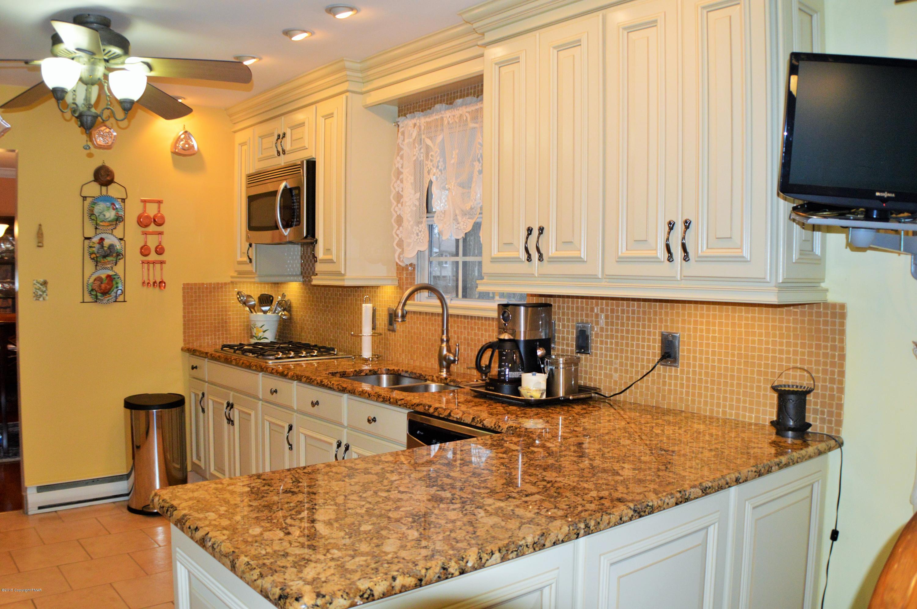 2105 Laurel Ridge Road East Stroudsburg, PA 18302 - Photo 18 of 82 a kitchen with stainless steel appliances granite countertop a sink a stove and a wooden cabinets