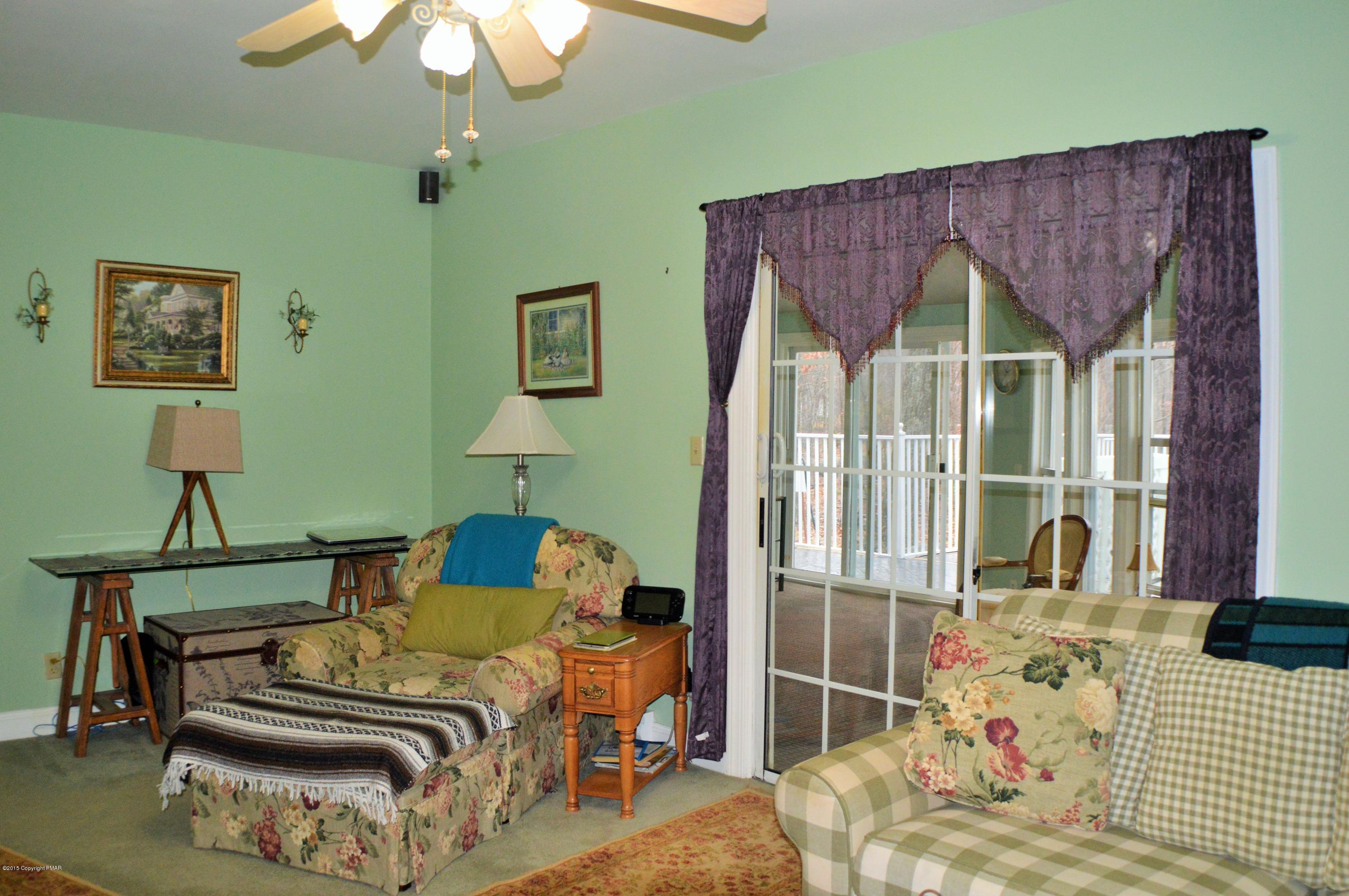 2105 Laurel Ridge Road East Stroudsburg, PA 18302 - Photo 30 of 82 a bedroom with a bed and a chandelier