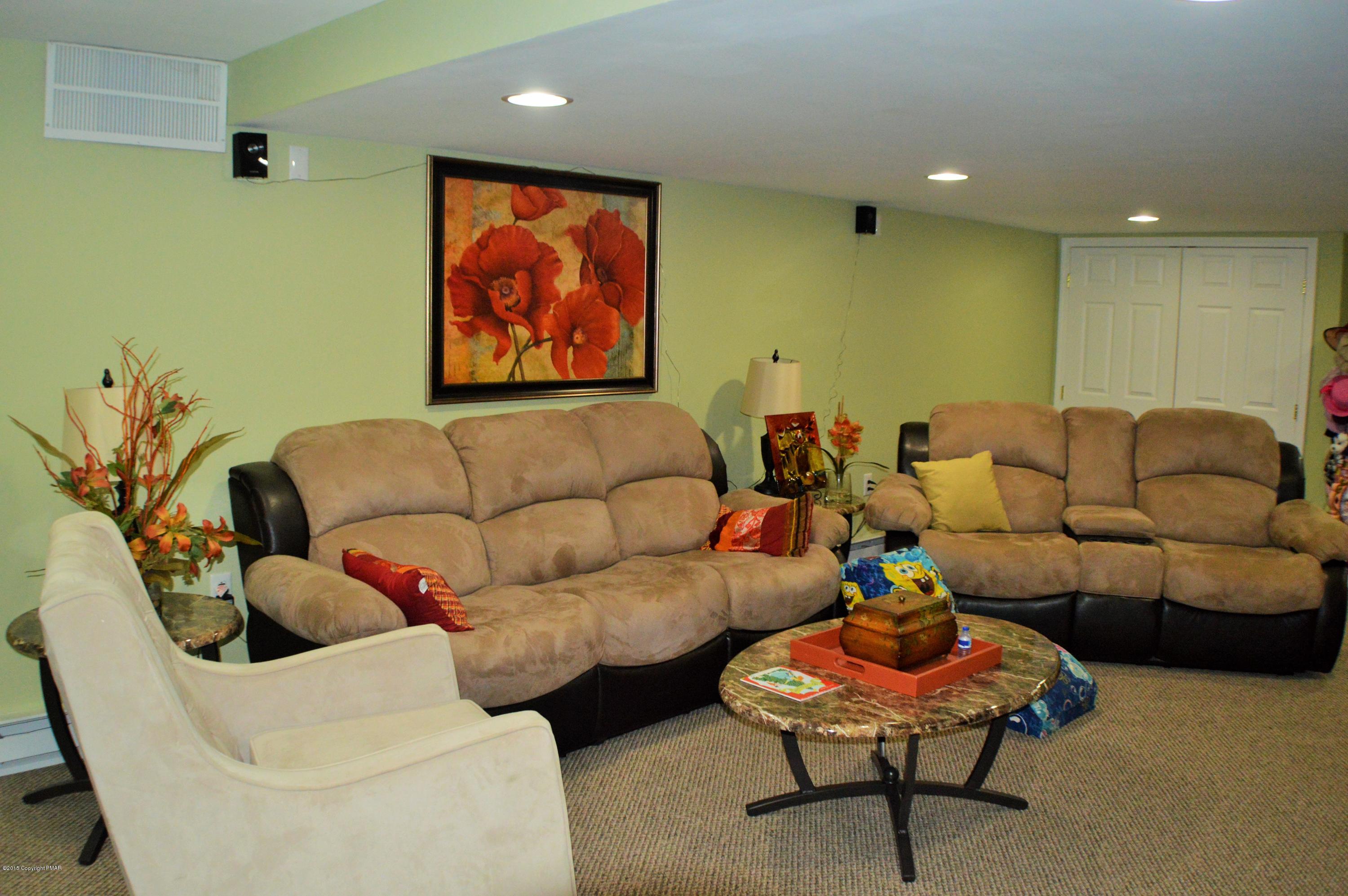 2105 Laurel Ridge Road East Stroudsburg, PA 18302 - Photo 56 of 82 a living room with furniture and a painting on the wall