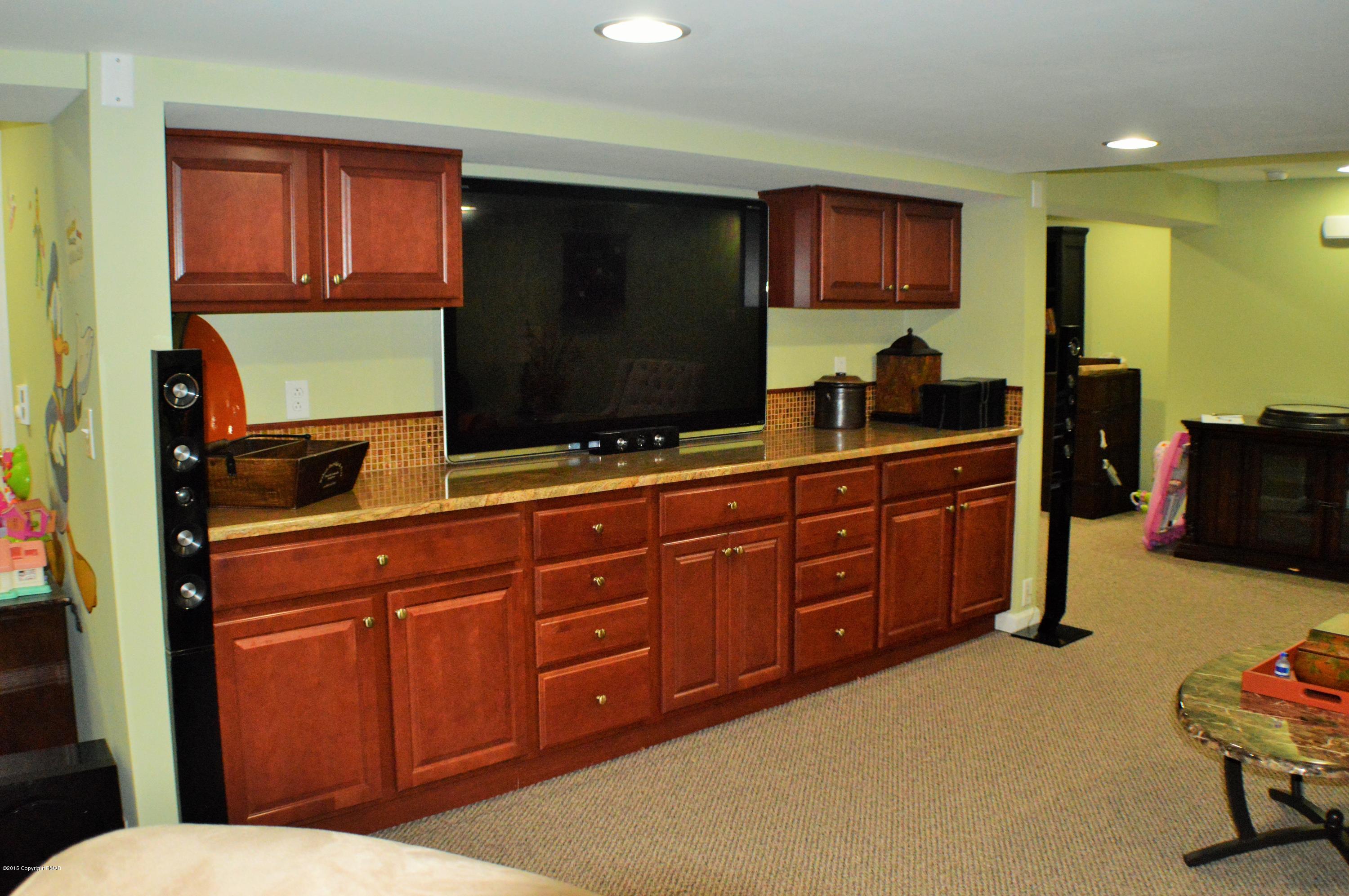 2105 Laurel Ridge Road East Stroudsburg, PA 18302 - Photo 58 of 82 a living room with wooden cabinets furniture and a flat screen tv