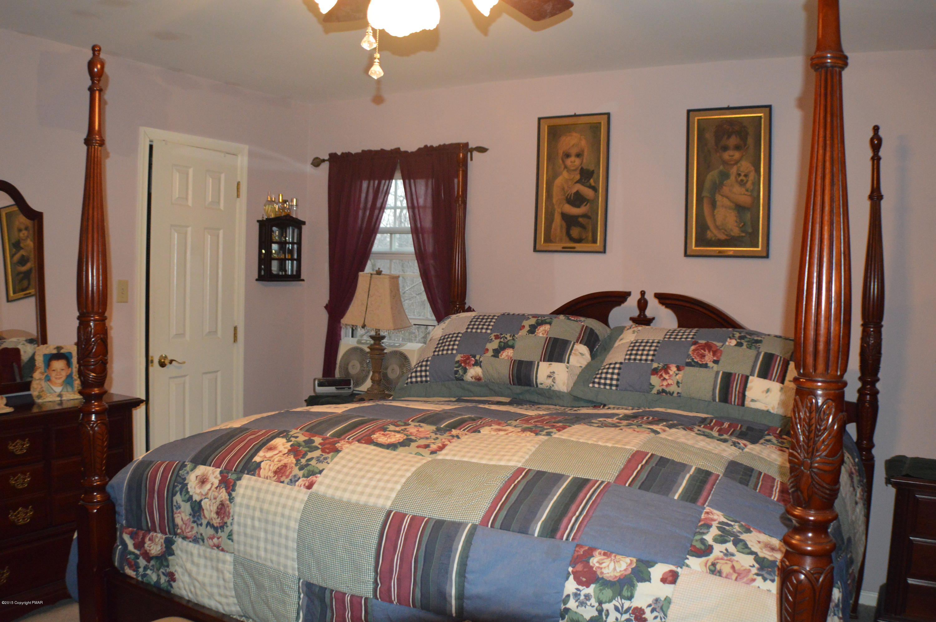 2105 Laurel Ridge Road East Stroudsburg, PA 18302 - Photo 9 of 82 a bedroom with a bed and a chandelier