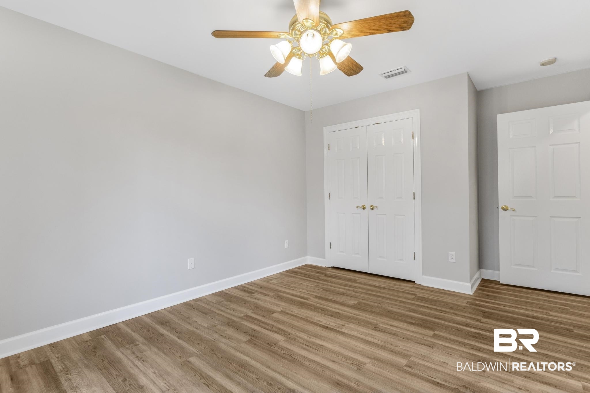 8077 Hooks Road Bay Minette, AL 36507 - Photo 24 of 48 Unfurnished bedroom featuring light wood-type flooring, a closet, and ceiling fan