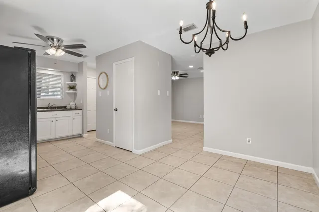 a view of a kitchen with wooden cabinet and a refrigerator
