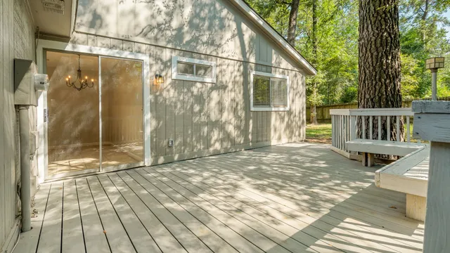 a backyard of a house with barbeque oven table and chairs