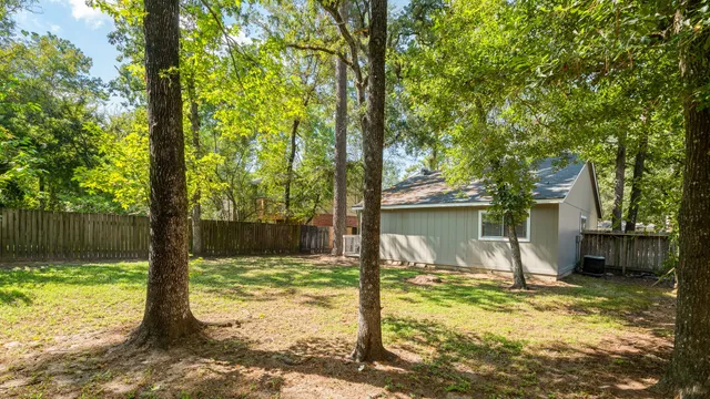 a view of a house with backyard from a tree