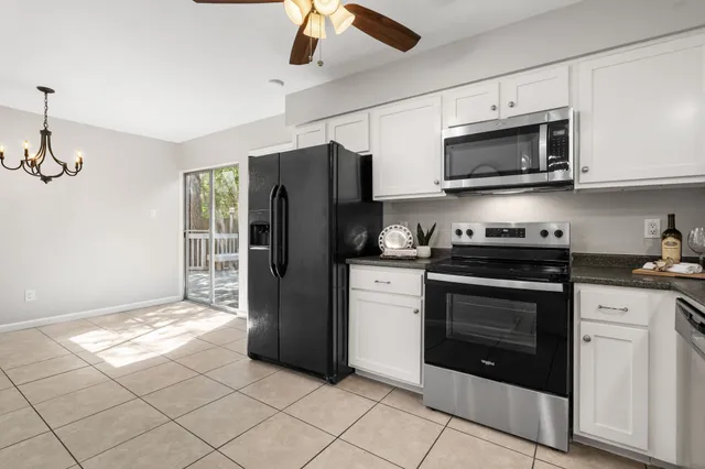 a kitchen with stainless steel appliances granite countertop a refrigerator and a stove top oven