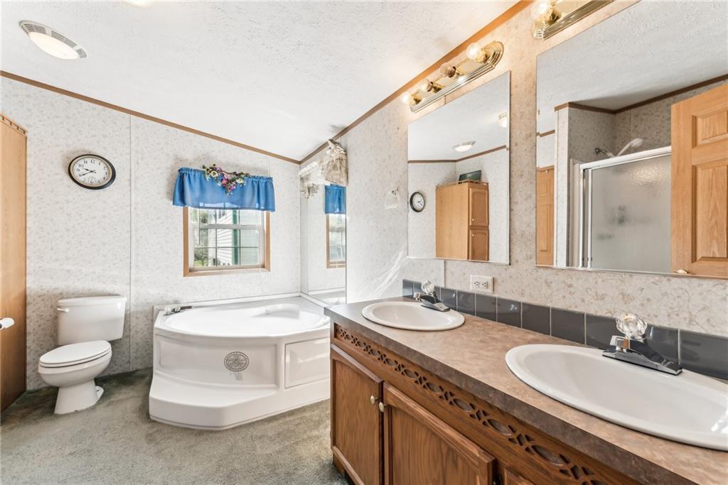 176 Seger Road Derry, PA 15627 - Photo 18 of 41 a spacious bathroom with a double vanity sink toilet mirror and bathtub