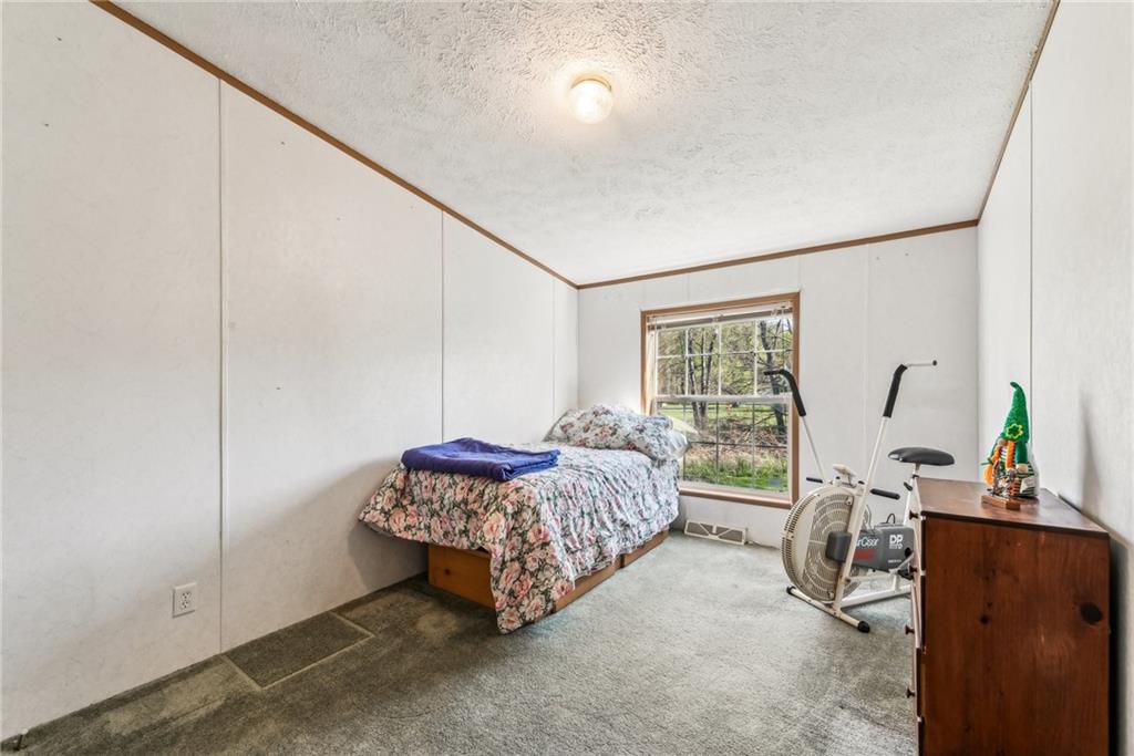 176 Seger Road Derry, PA 15627 - Photo 21 of 41 a living room with a bed furniture and a window