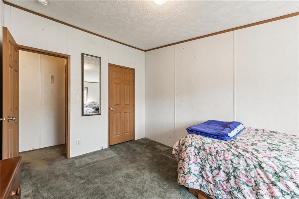 176 Seger Road Derry, PA 15627 - Photo 22 of 41 a bedroom with a bed and a dresser