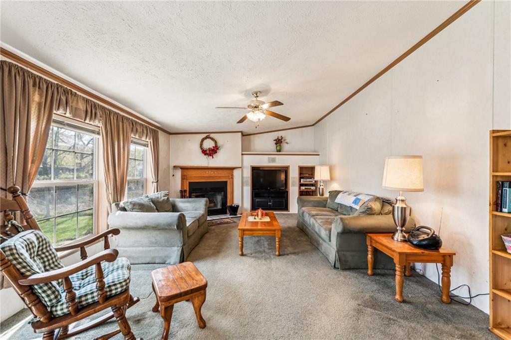176 Seger Road Derry, PA 15627 - Photo 9 of 41 a living room with fireplace furniture and a large window