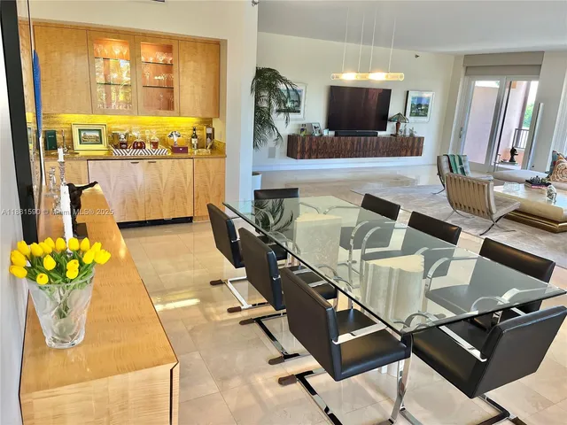 a living room with furniture a window and a flat screen tv