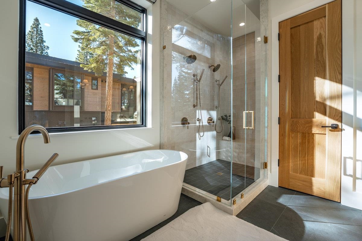 9308 Nine Bark Road Truckee, CA 96161 - Photo 13 of 28 a bathroom with a tub a mirror and a shower