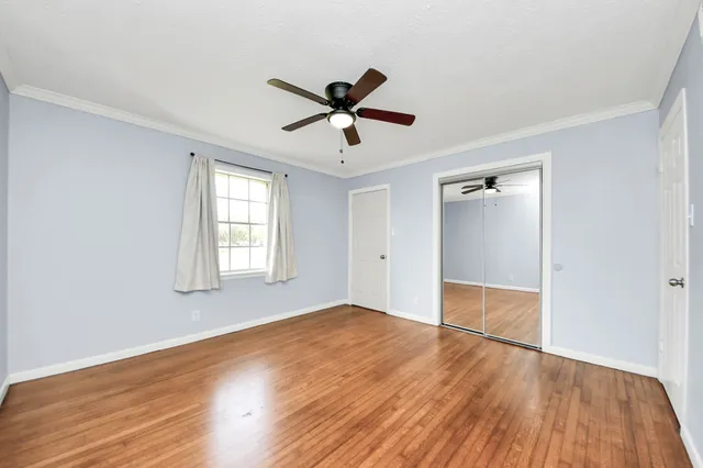 wooden floor in an empty room with a window