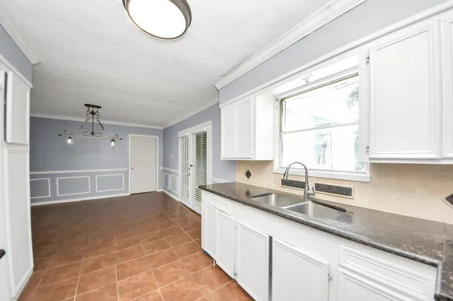 a kitchen with a sink cabinets and window