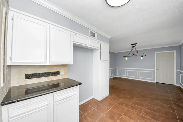 a kitchen with a cabinets and window