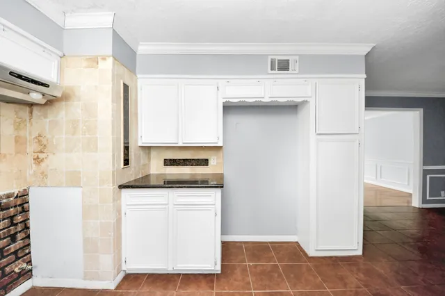 a kitchen with a sink cabinets and appliances