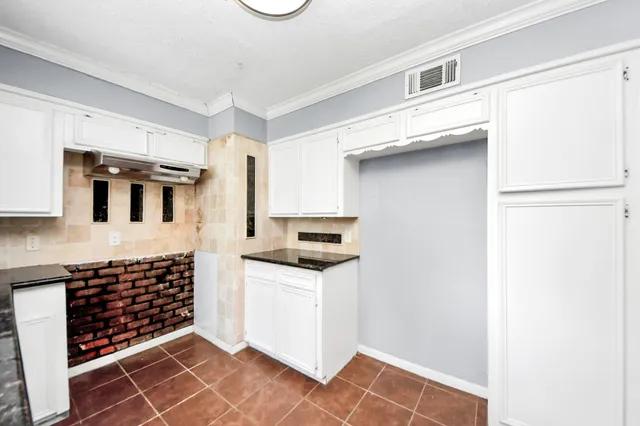 a kitchen with stainless steel appliances a stove a sink and a refrigerator