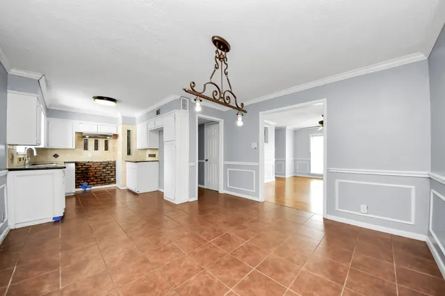 a view of a kitchen with a sink and a refrigerator