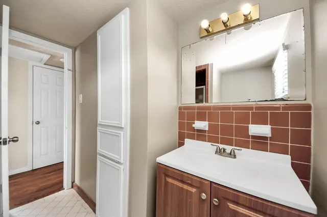 a bathroom with a sink and a mirror