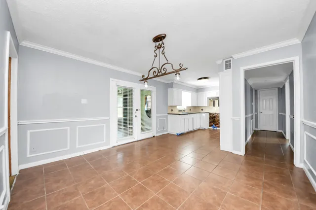 a view of a kitchen with refrigerator and windows