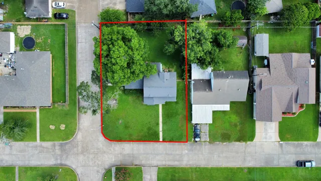 front view of a house with a yard and potted plants