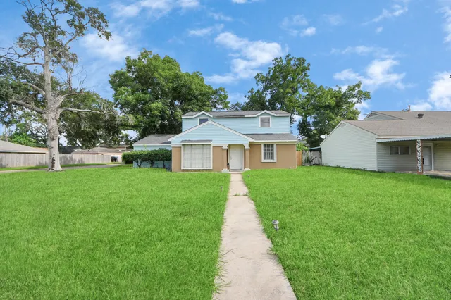 a front view of a house with a yard and porch
