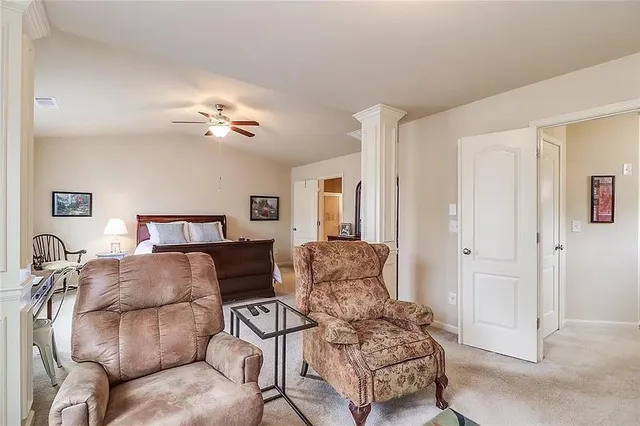 a living room with furniture a couch and chandelier
