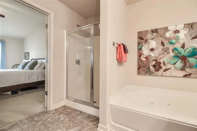 a bathroom with a bathtub and shower