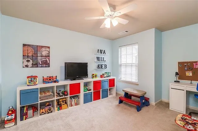 a living room with furniture a flat screen tv and a window