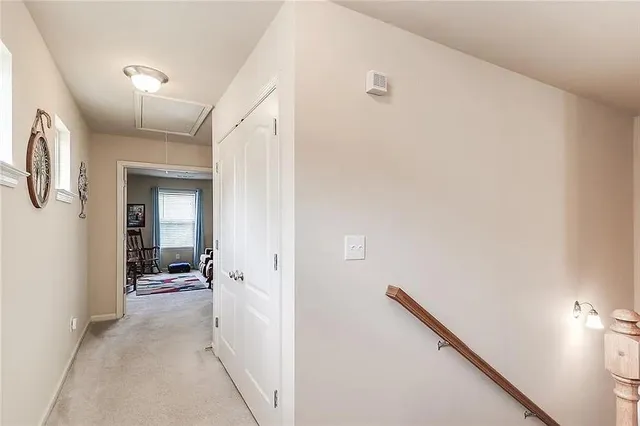a view of a hallway with closet and bathroom