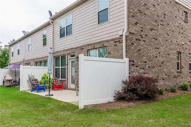 a view of a house with a yard and sitting area