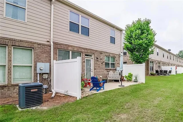 a backyard of a house with table and chairs